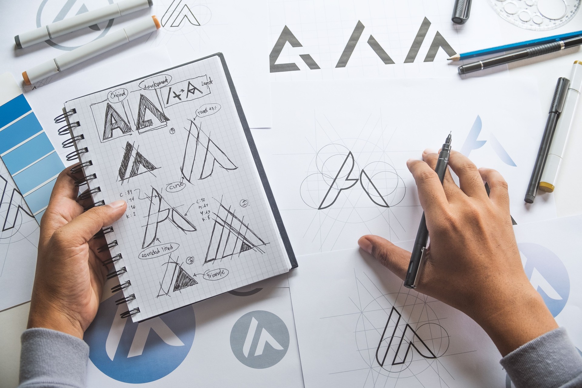 Graphic designer drawing sketch design creative Ideas draft Logo product trademark label brand artwork. Graphic designer studio Concept.